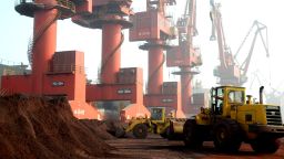 Workers transport soil containing rare earth elements for export at a port in eastern China's Jiangsu province.