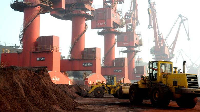 Workers transport soil containing rare earth elements for export at a port in eastern China's Jiangsu province.