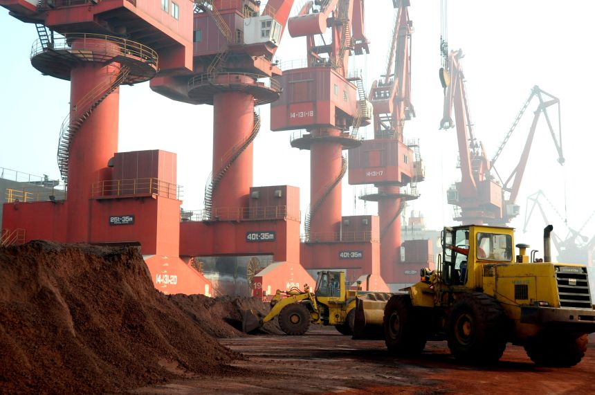 Workers transport soil containing rare earth elements for export at a port in Lianyungang, Jiangsu province, China.