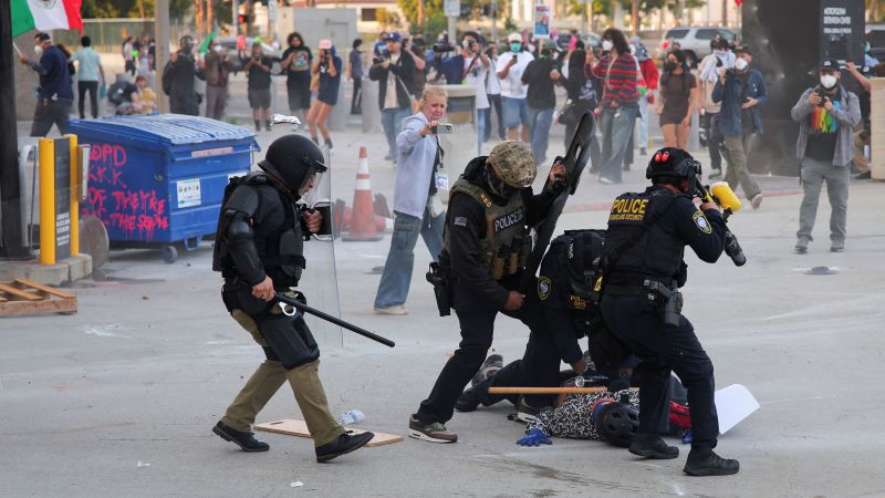 Officers throw flash bangs to disperse crowd protesting immigration enforcement in Los Angeles | CNN