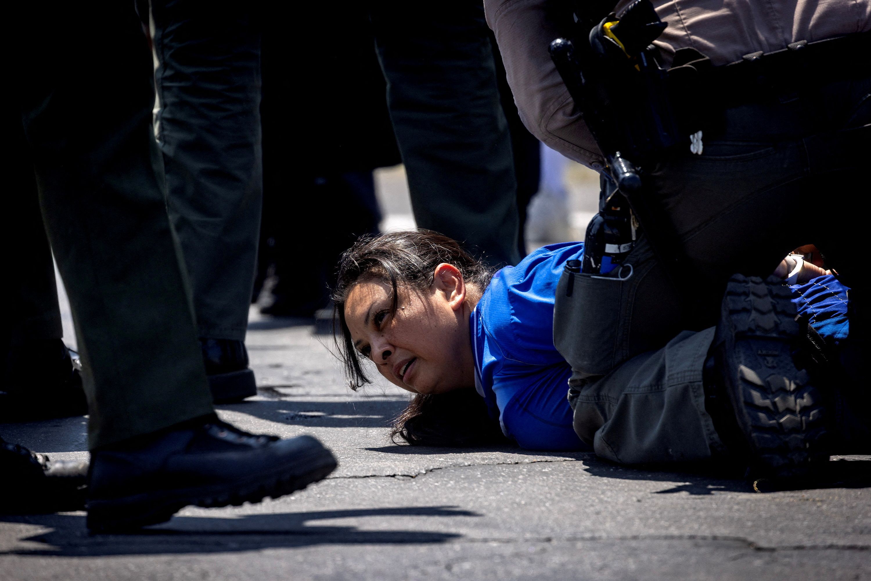 Los Angeles County Sheriff's deputies detain a woman during a standoff by protesters and law enforcement on Sunday.
