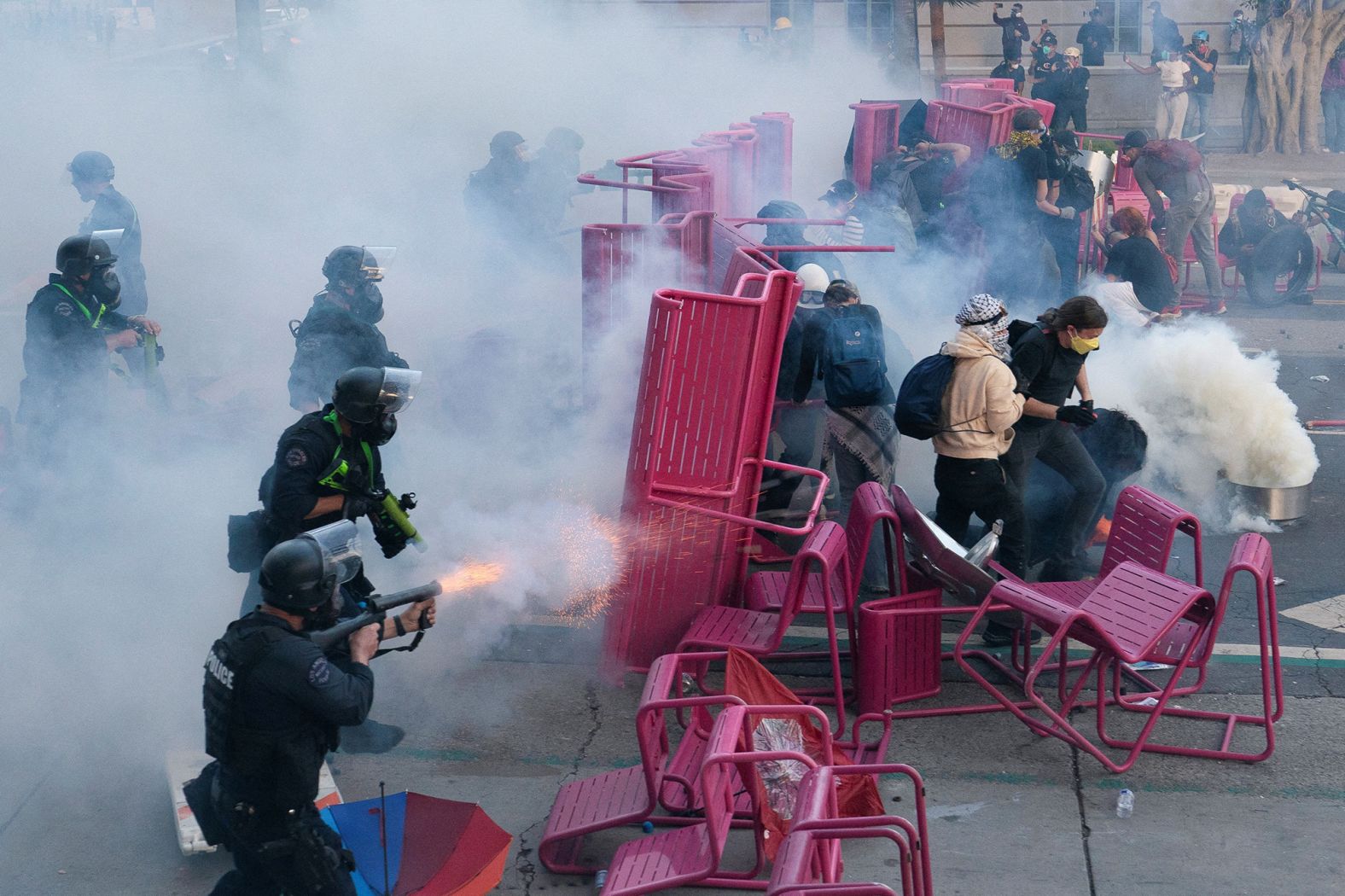Police clear demonstrators after they blocked a street with a barricade on Sunday.