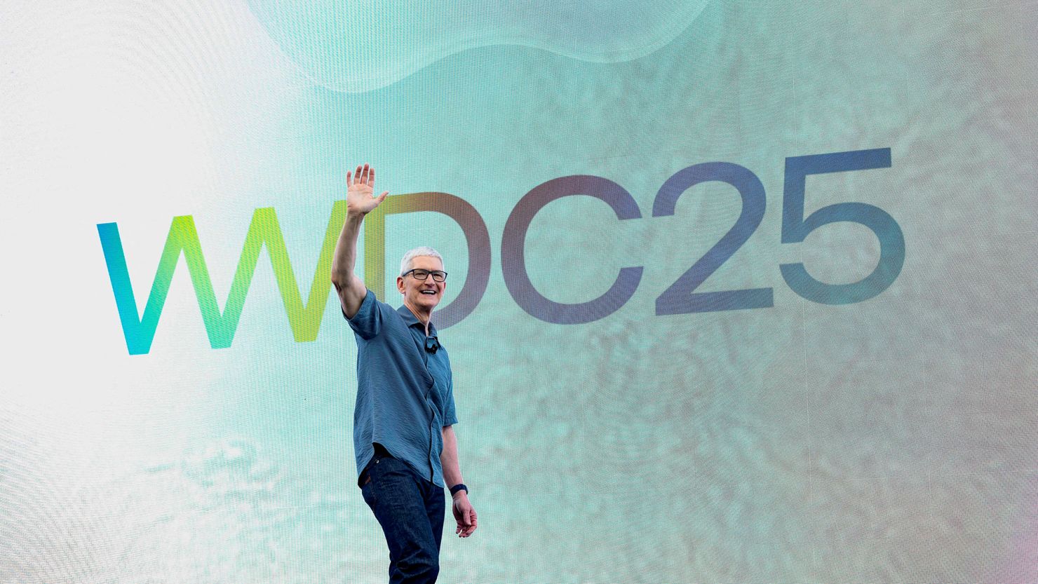 Apple CEO Tim Cook waves during Apple's annual World Wide Developers Conference at the company's headquarters in Cupertino, California, on June 9, 2025.