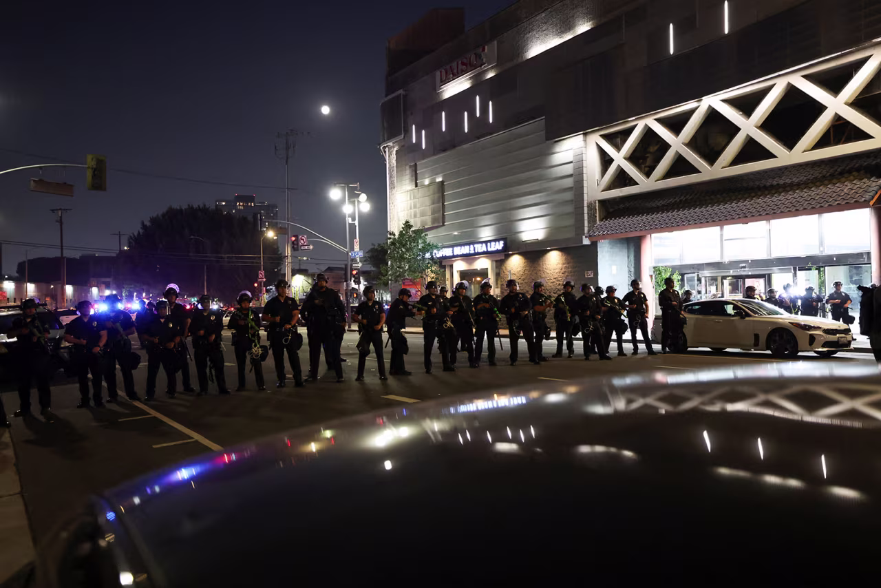 Law enforcement officers stand guard during a protest against federal immigration in downtown Los Angeles, California, on Monday.