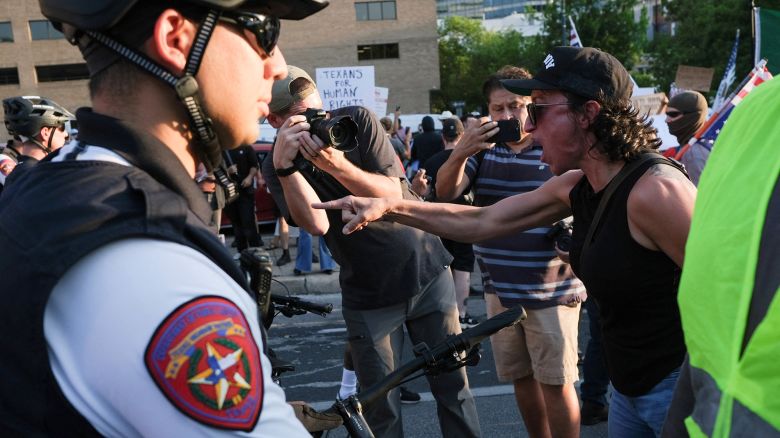 A demonstrator gestures at law enforcement officers during a rally in solidarity with Los Angeles protests against federal immigration sweeps, in Austin, Texas, U.S., June 9, 2025. REUTERS/Joel Angel Juarez