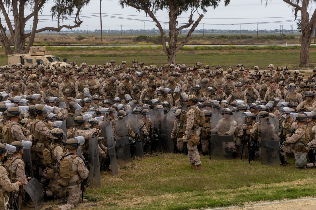 US. Marines with 2nd Battalion, 7th Marine Regiment, 1st Marine Division, who were placed in an alert status over the weekend, are briefed by battalion leadership while rehearsing crowd control tactics at a base in the greater Los Angeles area on Tuesday.
