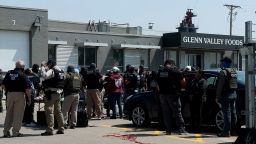 Federal agents stand with workers during a raid by U.S. Immigration and Customs Enforcement (ICE) at a Glenn Valley Foods meat production plant in Omaha, Nebraska, U.S. June 10, 2025 in a still image from video. U.S. Immigration and Customs Enforcement/Handout via REUTERS. THIS IMAGE HAS BEEN SUPPLIED BY A THIRD PARTY
