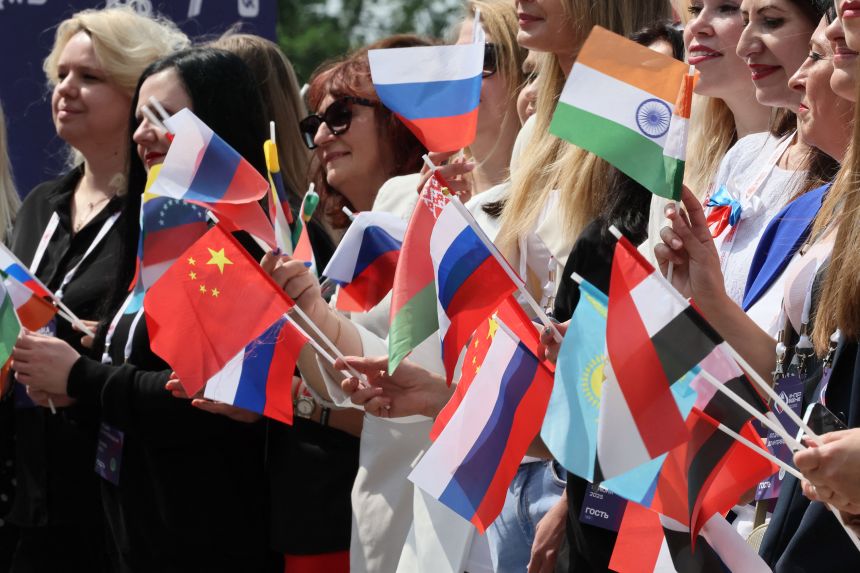 Audiences wave various flags during the ceremony marking the countdown to the start of the Interdiss Song Contest.