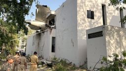 A tail of an Air India Boeing 787 Dreamliner plane that crashed is seen stuck on a building after the incident in Ahmedabad, India, June 12, 2025. REUTERS/Amit Dave