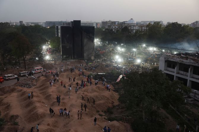 People gather near the site of the crash on Thursday, June 12.