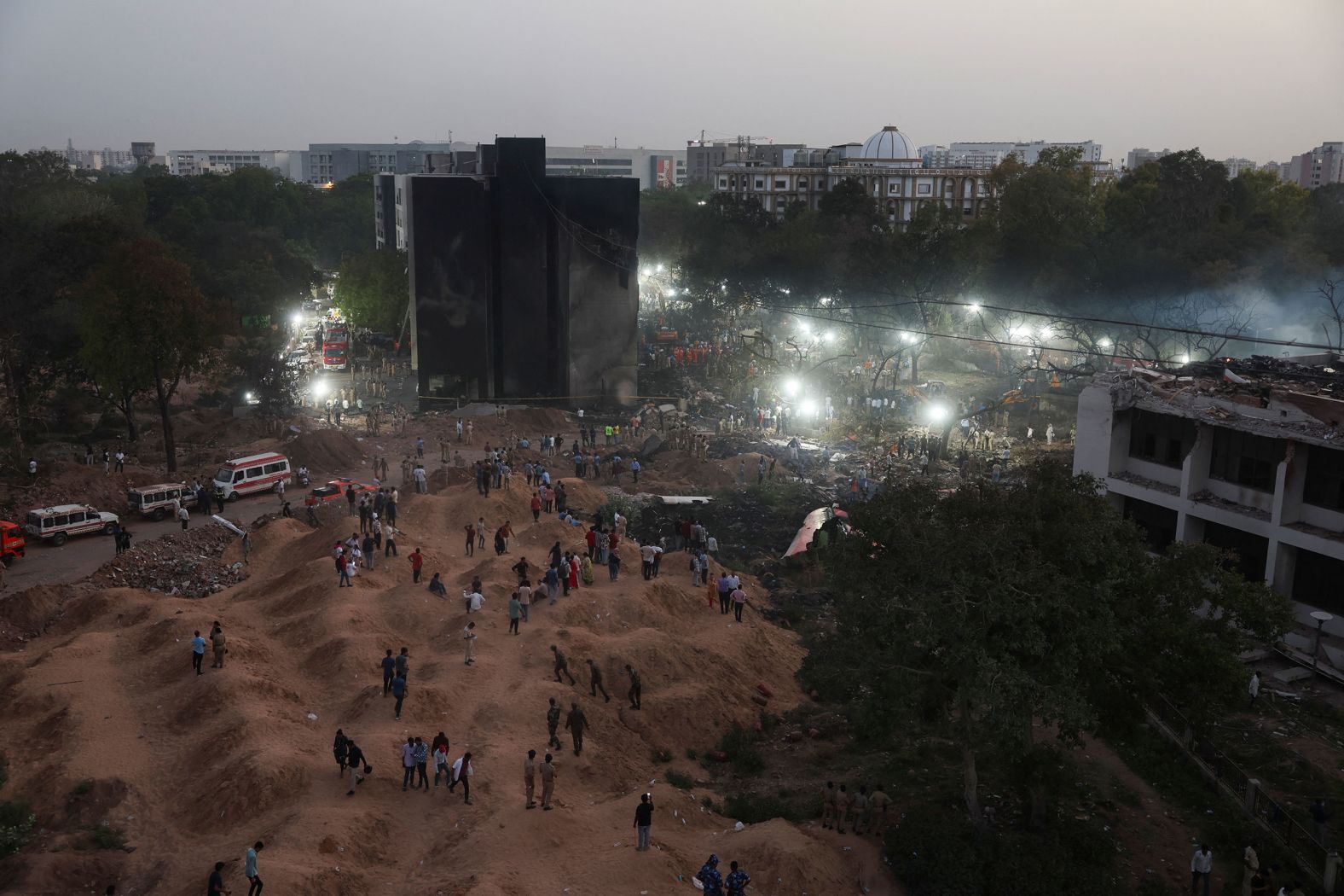 People gather near the site of the crash on Thursday, June 12.