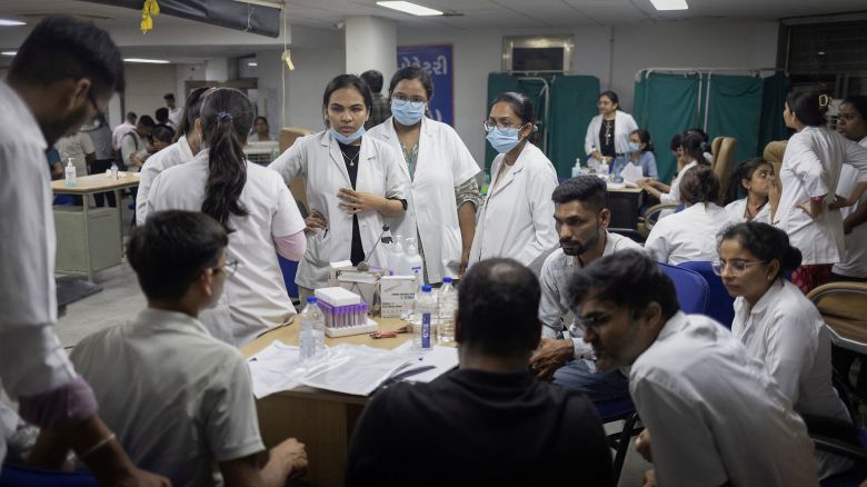 Health officials wait to take DNA samples from family members of the victims who died when an Air India Boeing 787-8 Dreamliner plane bound for London's Gatwick Airport, crashed during take-off from Ahmedabad, at a hospital in Ahmedabad, India June 12, 2025. REUTERS/Adnan Abidi