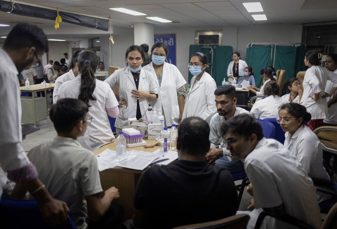 Health officials take DNA samples from family members of the victims who died when an Air India plane bound for London's Gatwick Airport crashed shortly after take-off from Ahmedabad, India on June 12, 2025.