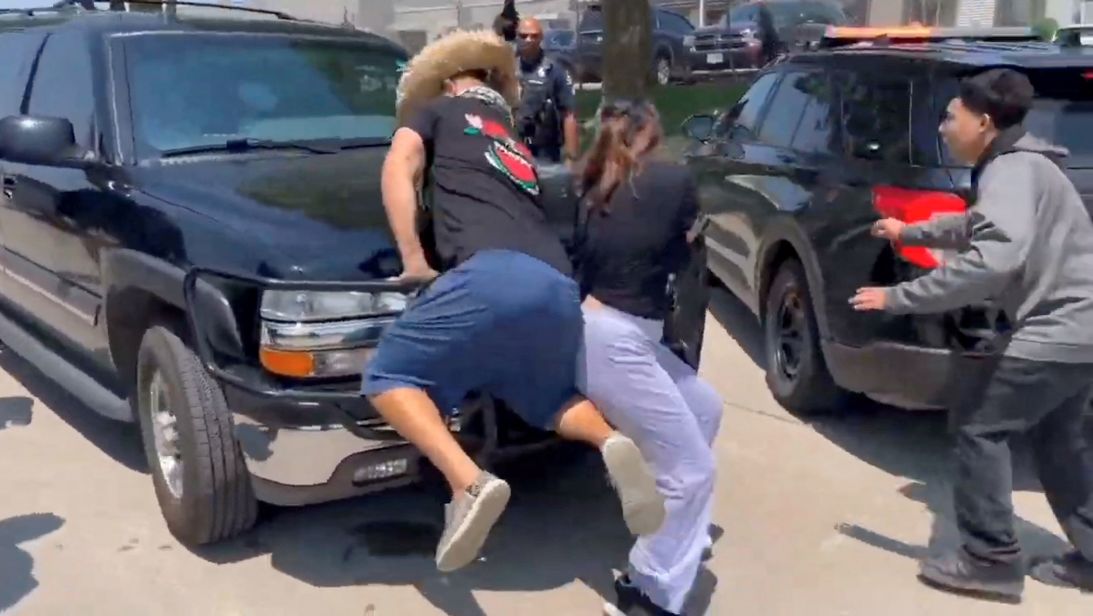 Protesters attempt to obstruct a vehicle during the operation at the plant.