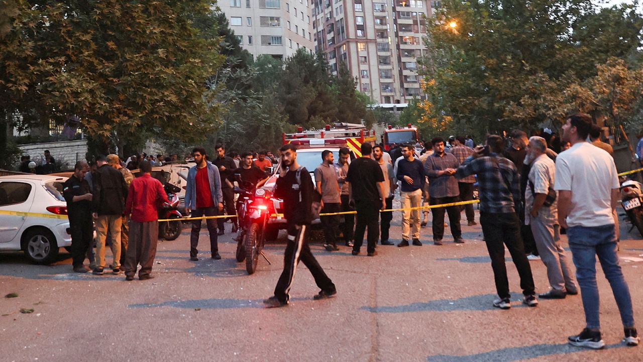 People gather in the street in the aftermath of Israeli strikes, in Tehran, Iran, June 13, 2025.