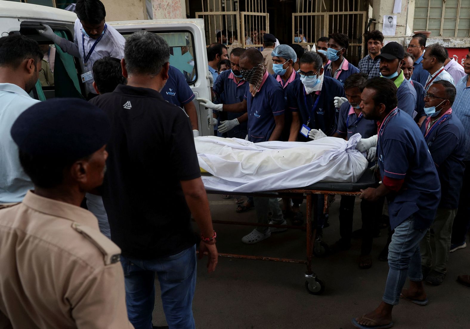 Hospital staff load the body of a plane crash victim into a vehicle at the Civil Hospital in Ahmedabad on Friday.