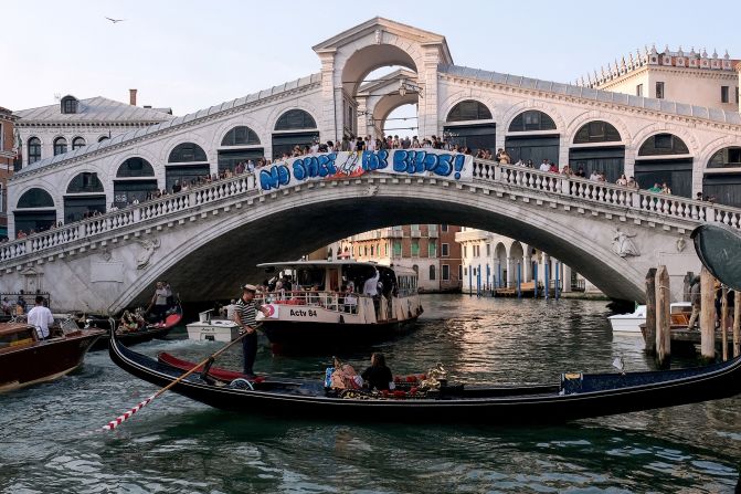 Protesters display a banner reading "No space for Bezos!" on the Rialto Bridge in Venice on June 13.