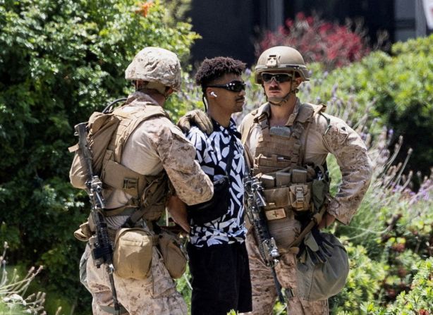 US Marines temporarily detain Marcos Leao outside the Wilshire Federal Building in Los Angeles on Friday. Leao is an Army veteran who was on his way to an office of the Department of Veterans Affairs when he crossed a yellow tape boundary. <a  target="_top" href="/newspapers?url=https://www.reuters.com/world/us/us-marines-carry-out-first-known-detention-civilian-los-angeles-video-shows-2025-06-13/" target="_blank">The incident marks the first known detention by active-duty troops deployed to Los Angeles.</a>