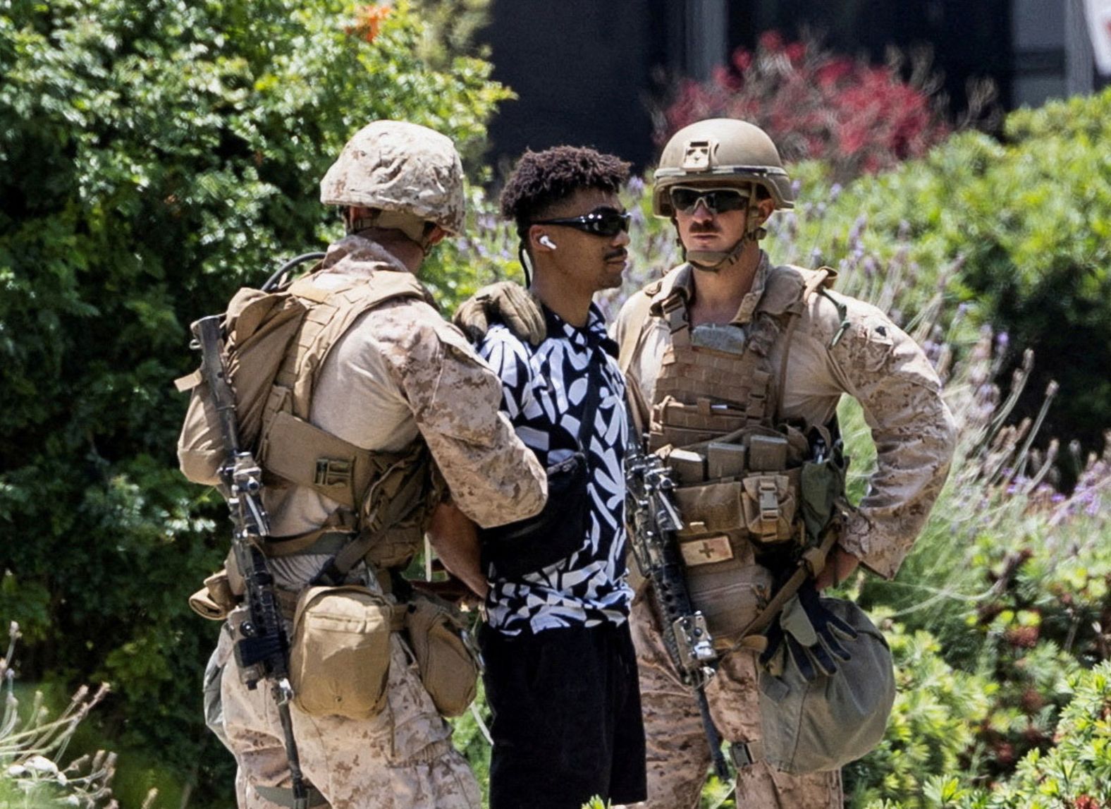 US Marines temporarily detain Marcos Leao outside the Wilshire Federal Building in Los Angeles on Friday. Leao is an Army veteran who was on his way to an office of the Department of Veterans Affairs when he crossed a yellow tape boundary. <a href="index.php?page=&url=https%3A%2F%2Fwww.reuters.com%2Fworld%2Fus%2Fus-marines-carry-out-first-known-detention-civilian-los-angeles-video-shows-2025-06-13%2F" target="_blank">The incident marks the first known detention by active-duty troops deployed to Los Angeles.</a>
