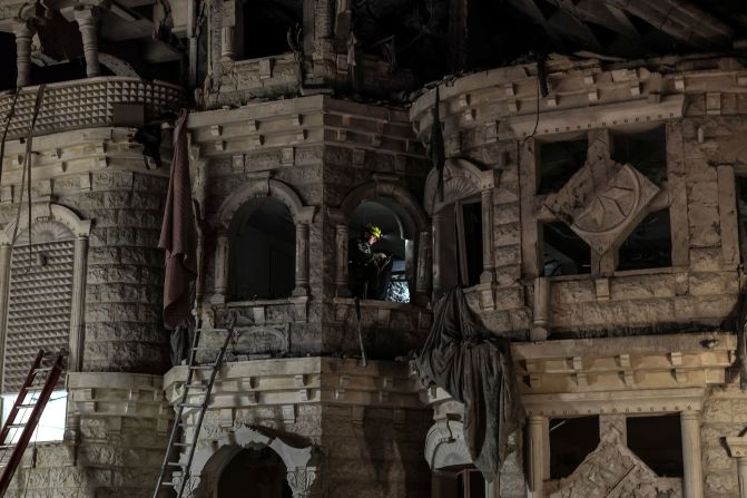A rescue worker sits inside a residential building <a href="https://www.cnn.com/world/live-news/israel-iran-strikes-news-06-14-25#cmbwr96vk001c3b6mlm8orrlm">damaged by missiles fired from Iran</a> in Tamra, Israel, on Sunday.