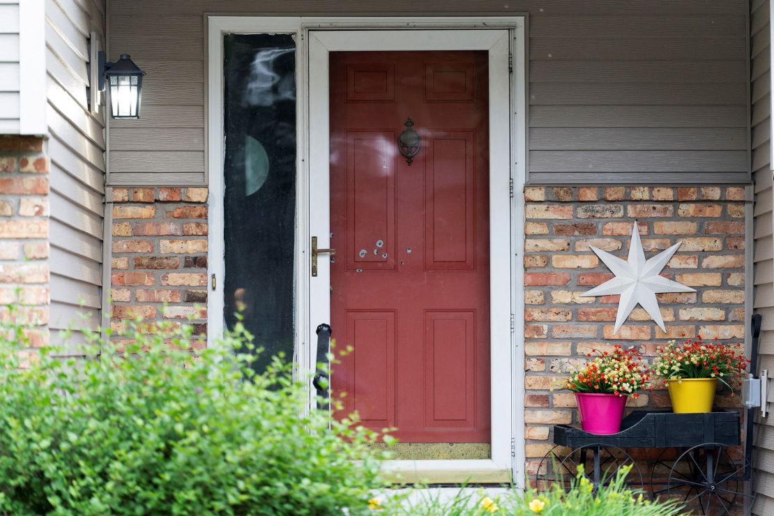 Bullet holes mark the front door of Minnesota State Sen. John Hoffman, who was shot alongside his wife, Yvette, in Champlin, Minnesota, on Saturday.