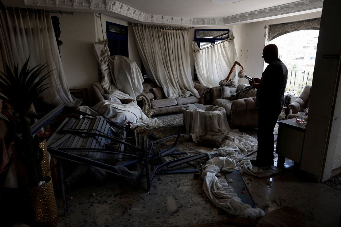 A man stands inside a damaged room after missiles fired from Iran impacted a residential building in Tamra, northern Israel June 15, 2025.