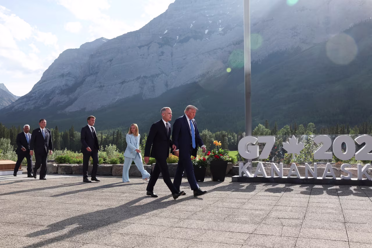 President Donald Trump, walking with Canadian Prime Minister Mark Carney, arrives for a family photo during the G7 Summit with European Council President Antonio Costa, Japanese Prime Minister Shigeru Ishiba, Italian Prime Minister Giorgia Meloni and French President Emmanuel Macron in Kananaskis, Alberta, Canada, on Monday.