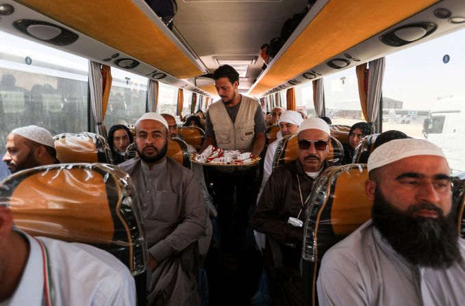 Iranian pilgrims who were rerouted through Iraq sit inside a bus at the Arar border crossing on Tuesday. They were unable to fly home because of the ongoing conflict between Iran and Israel.
