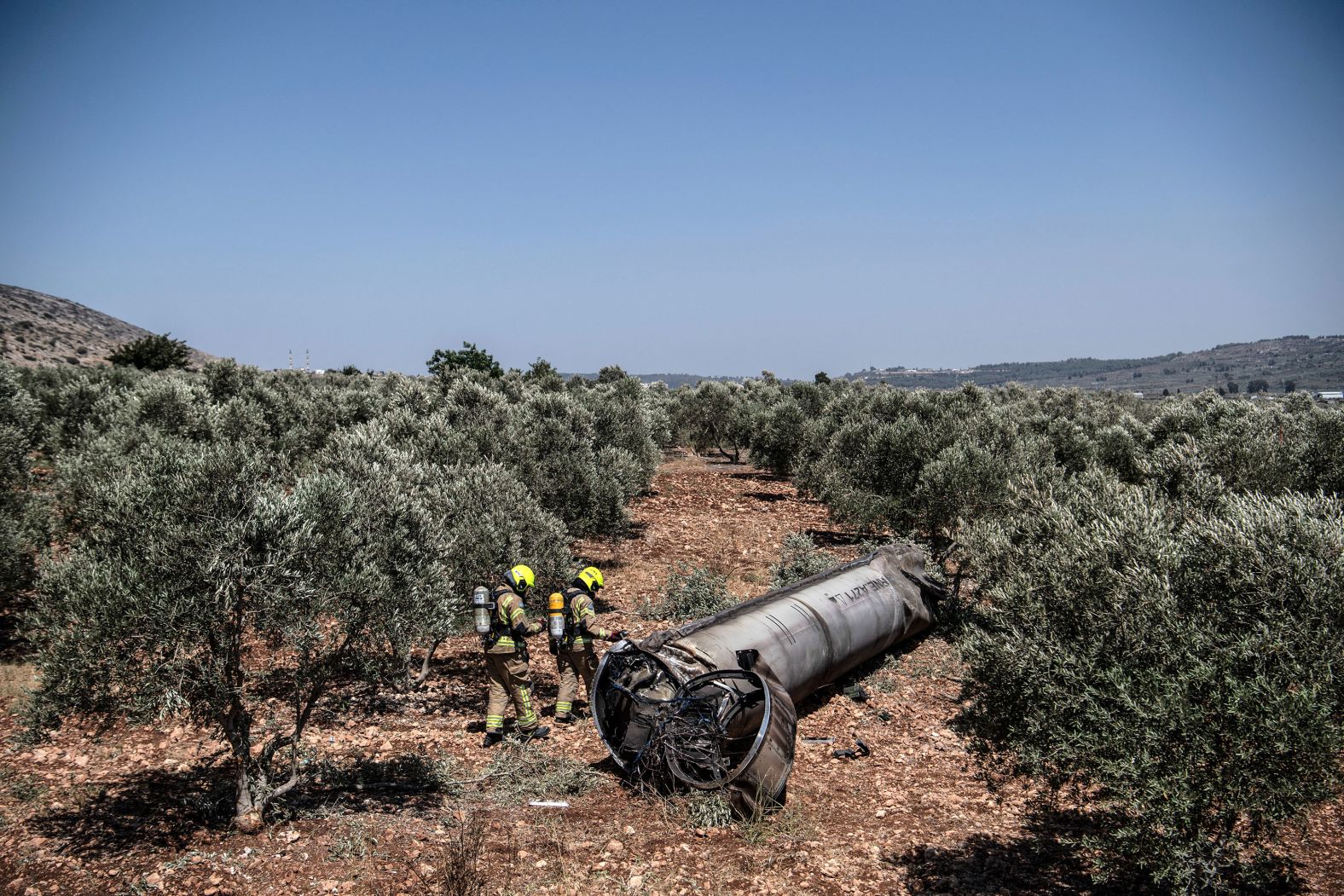 Members of the Israeli special forces check the apparent remains of a ballistic missile lying on the ground in northern Israel on June 18.