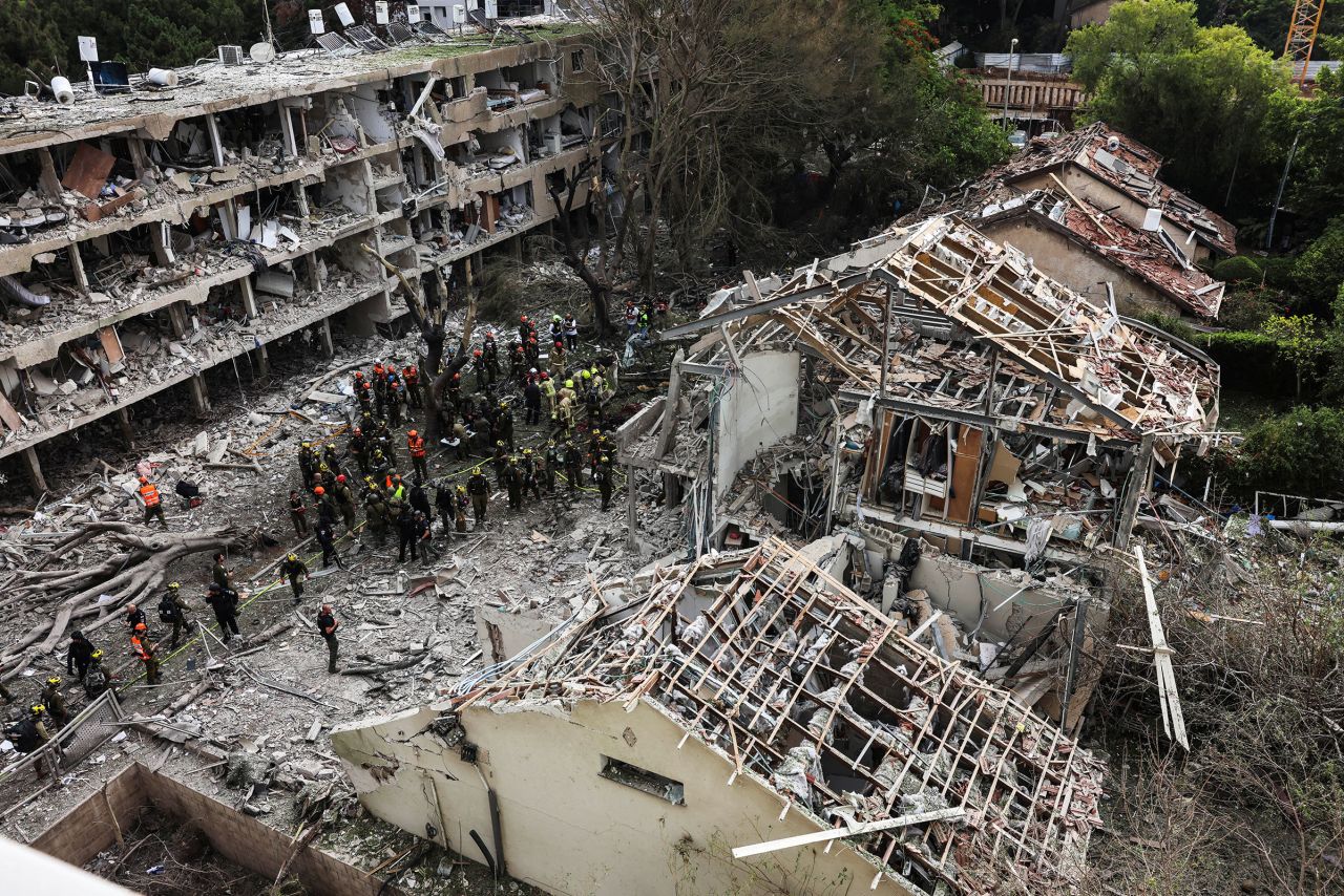 Rescuers and security personnel work at the site of an Iranian missile strike in Tel Aviv, Israel, on Sunday.