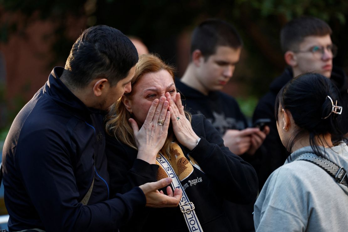 A woman reacts at the site of an apartment building hit during Russian drone and missile strikes, amid Russia's attack on Ukraine, in Kyiv, Ukraine June 23, 2025.
