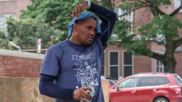 A landscaper puts a cold towel over his head during a heat wave in Queens, New York City, on Monday.