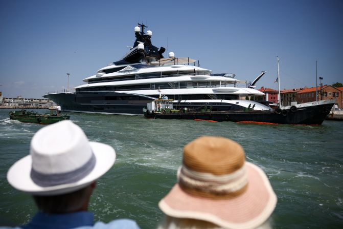 People look at a super yacht in Venice on Tuesday, June 24. Multimillion-dollar super yachts have been arriving in the city.