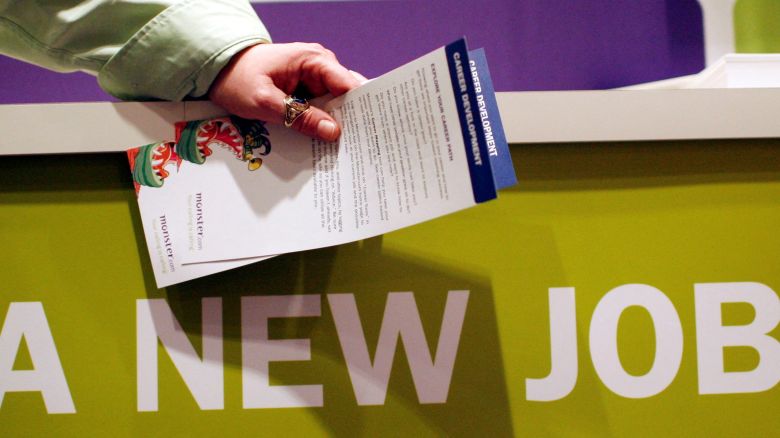 A man holds pamphlets as he waits at a job fair sponsored by employment website Monster.com in 2009. The website filed for bankruptcy 16 years later.