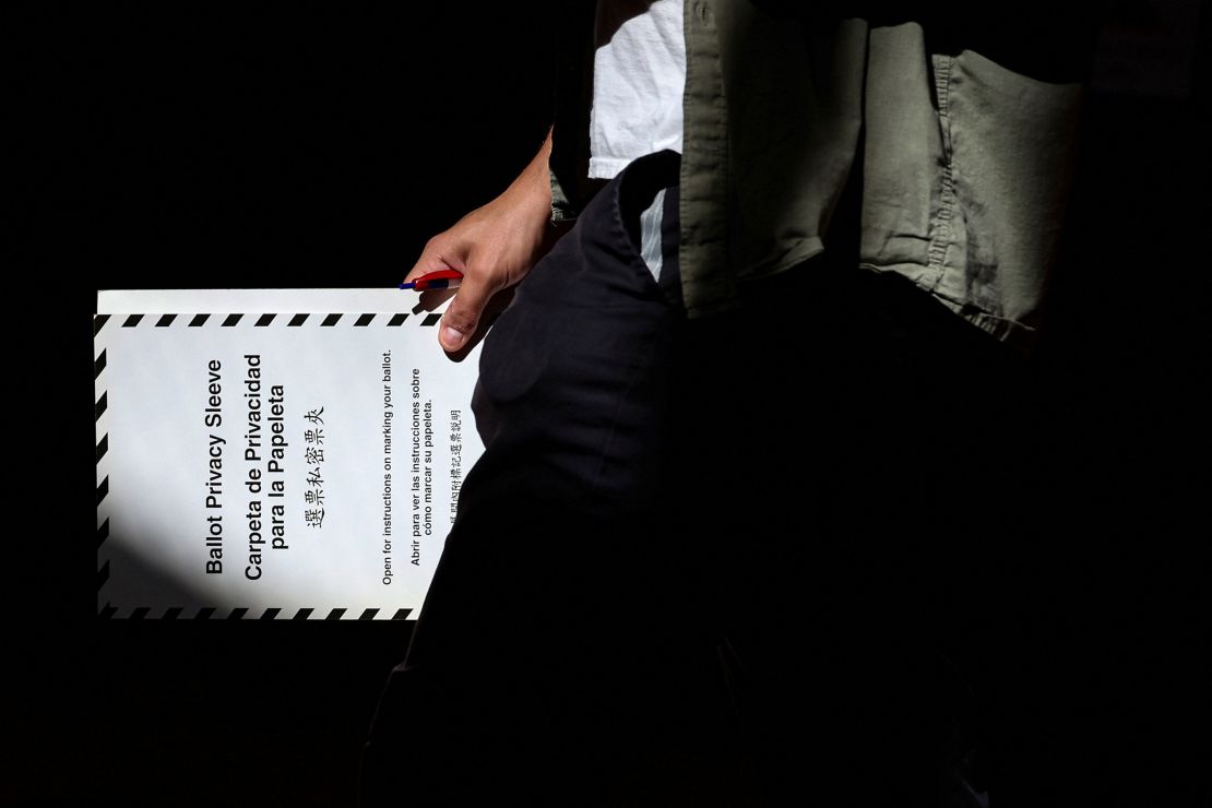 A voter carries a ballot while voting in the primary election, which includes the race for the Democratic candidate for New York City mayor in the November's election, in New York's Brooklyn borough on June 24.
