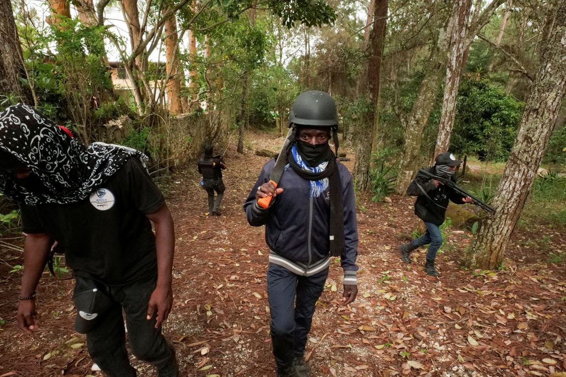 Members of a neighborhood watch patrol a residential area in Furcy, Haiti, on June 24, 2025, after gangs set homes on fire amid a surge in violence.