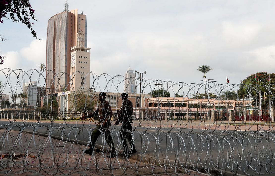 Security officers gather near a razor wire fence erected to block access to the Parliament buildings.