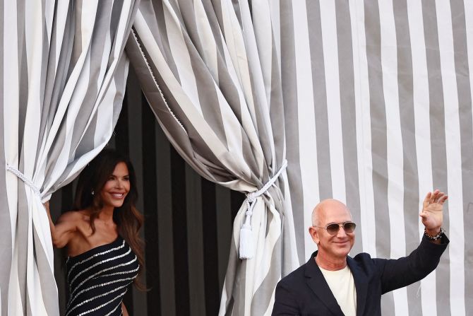 Sanchez and Bezos depart the Aman Venice hotel on Wednesday. Bezos' bride-to-be was photographed in a vintage Spring-Summer 2003 off-the-shoulder McQueen dress.
