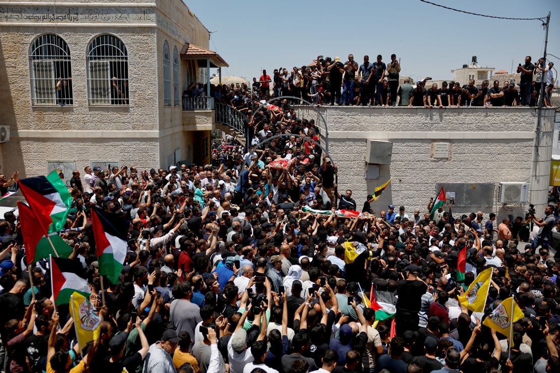 Mourners carry the bodies of young Palestinians who were killed by Israeli settlers in Kafr Malik. The UN has warned that there is 