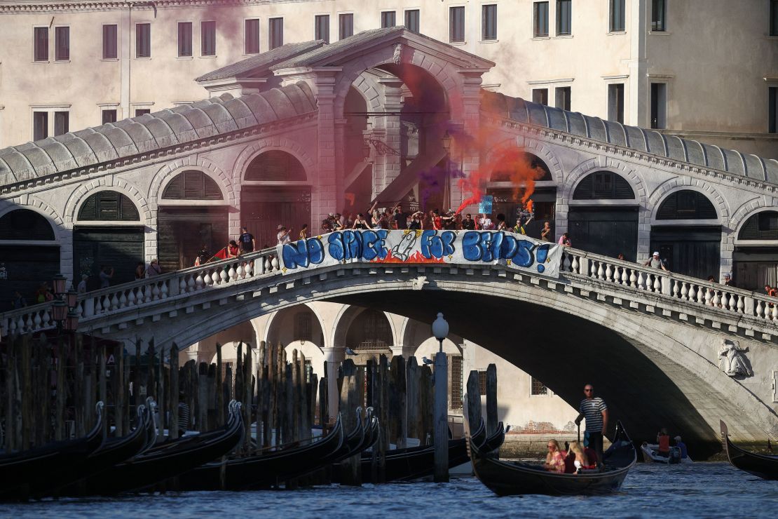 Demonstrators on the Rialto Bridge stand by a banner that reads 'No space for Bezos' in Venice on Saturday.