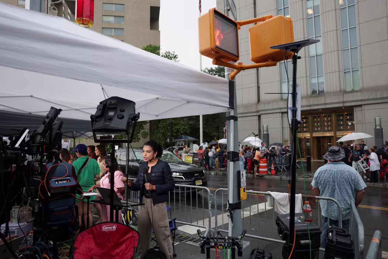Members of the media report outside federal court in New York on Tuesday.