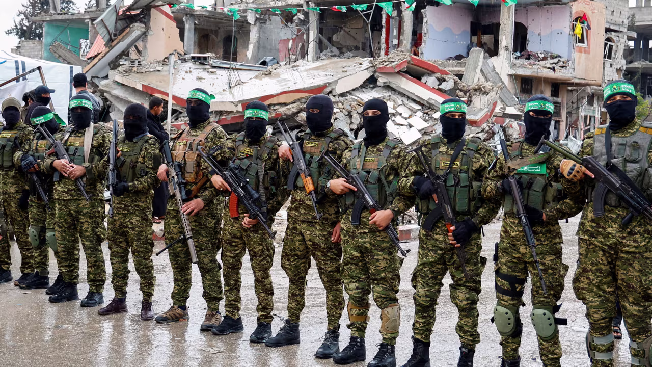 Hamas militants stand guard in Rafah during a handover of Israeli hostages as part of a ceasefire and a hostages/prisoners swap deal between Hamas and Israel on February 22.