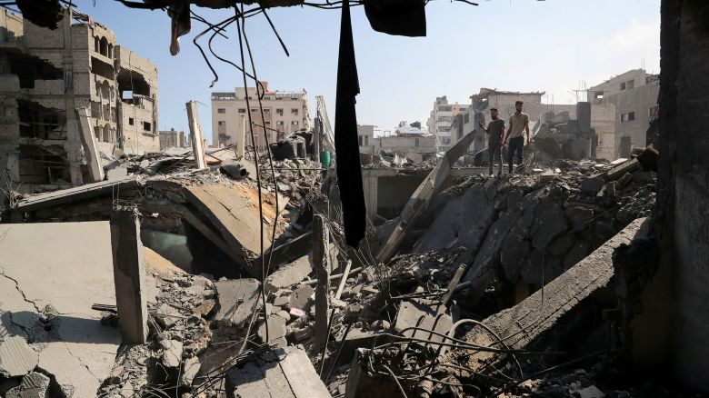 Palestinians inspect the site of an Israeli strike that damaged and destroyed residential buildings, at Shati refugee camp, in Gaza City, July 4, 2025.