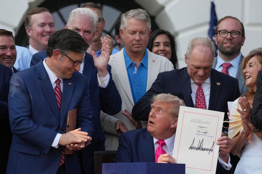 House of Representatives Speaker Mike Johnson claps as President Donald Trump presents the sweeping spending and tax legislation, known as the 