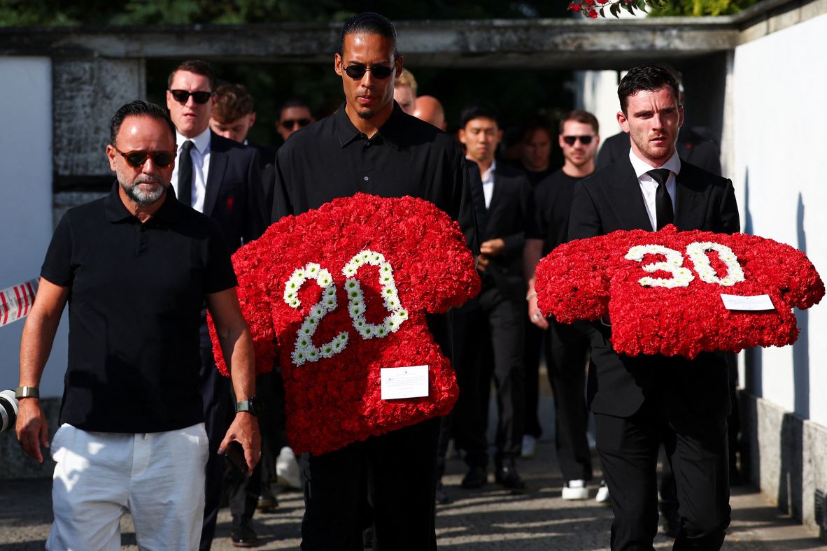 Liverpool players Virgil van Dijk and Andrew Robertson arrive for the funeral on Saturday, carrying bundles of flowers in the shape of Jota's and Silva's jerseys.