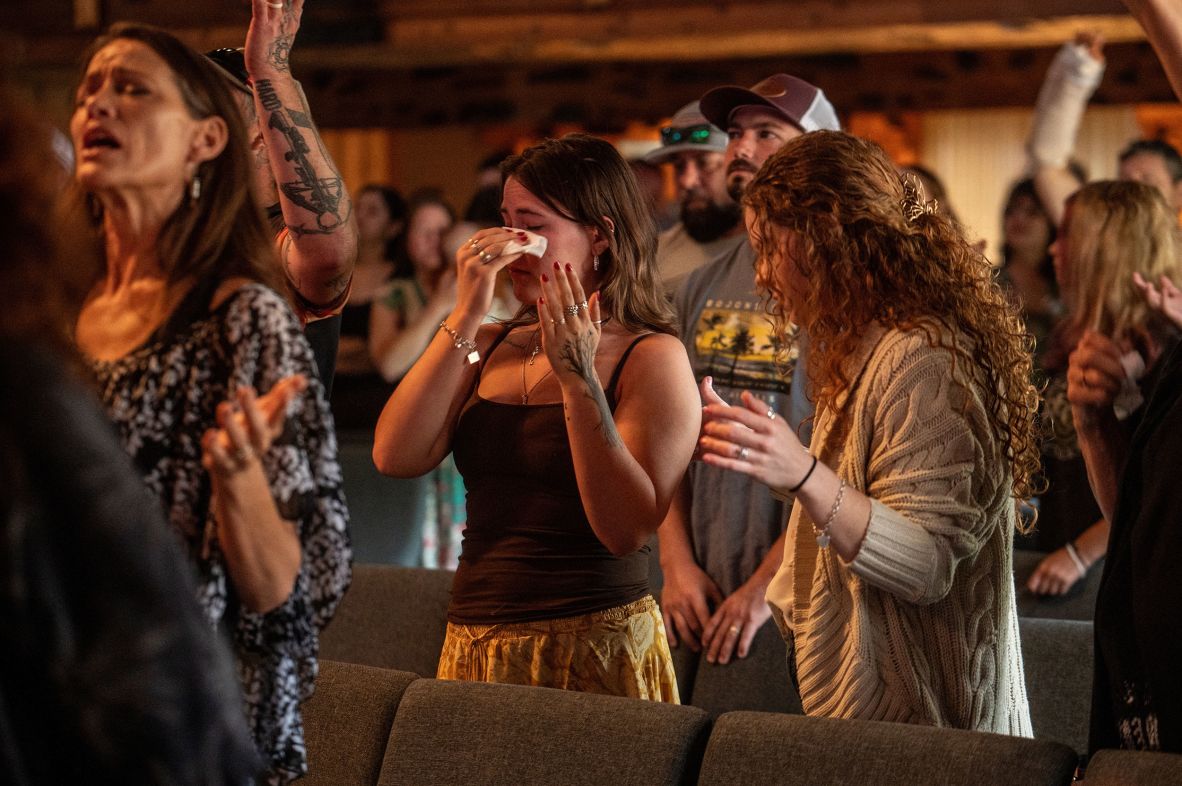 A woman reacts as churchgoers sing at a service in Kerrville on Sunday.