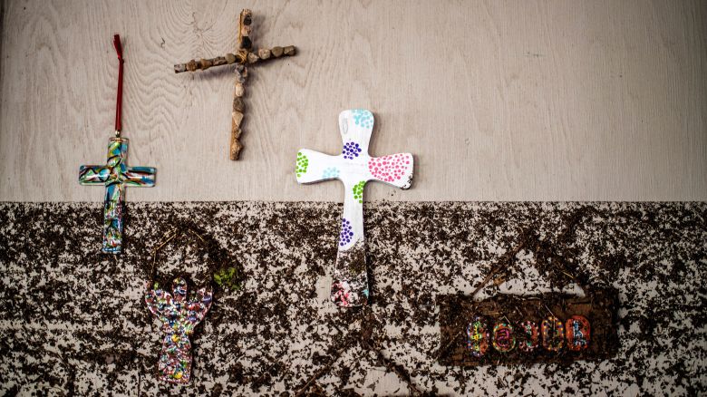 Crosses hang on a wall with flood marks at Camp Mystic in the aftermath of deadly flooding in Kerr County on July 7, 2025.