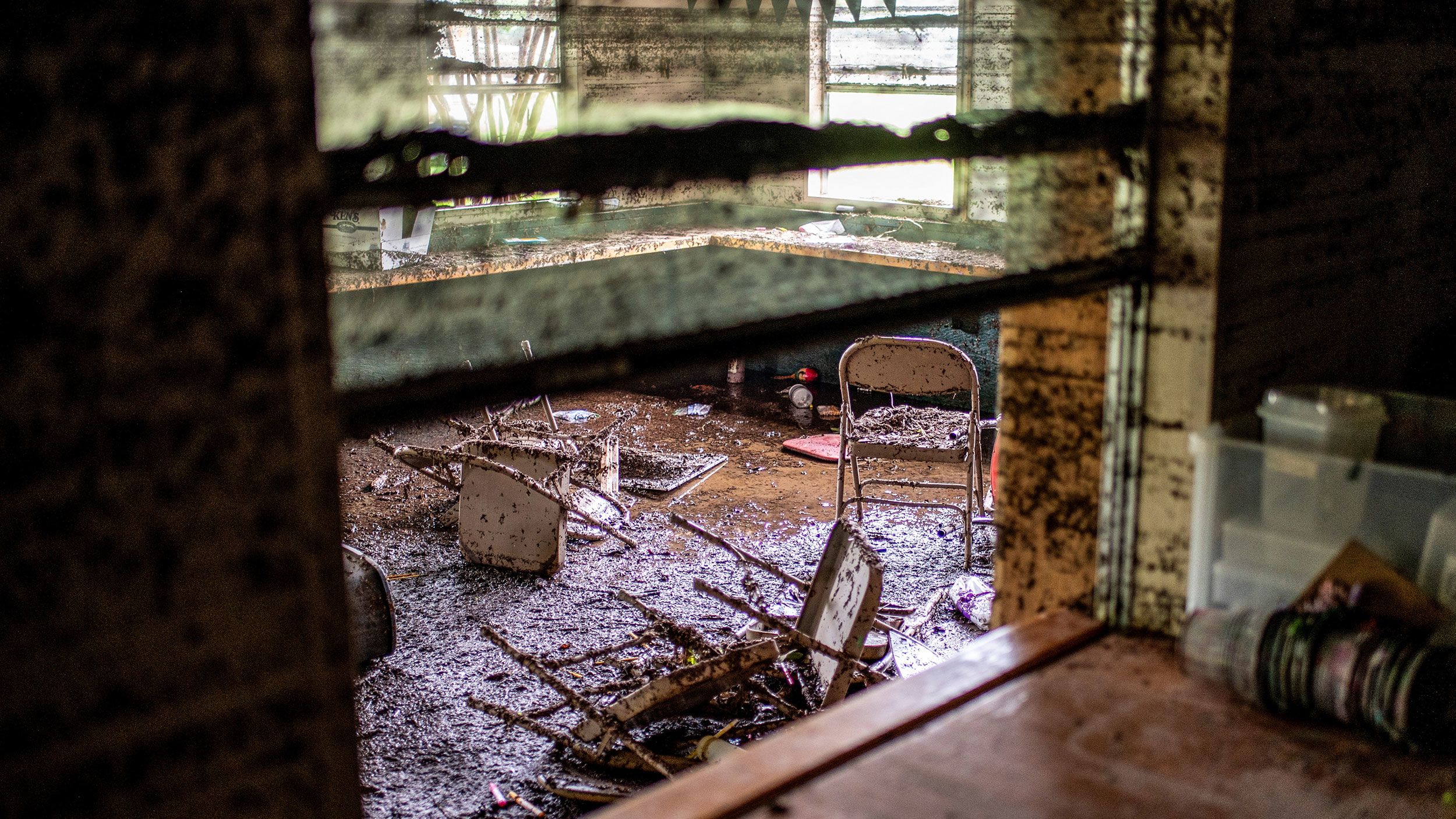 Chairs lie inside a damaged room in a cabin at Camp Mystic in the aftermath of deadly flooding in Kerr County, Texas, U.S., July 7, 2025.   REUTERS/Sergio Flores
Chairs covered in mug lie inside a damaged cabin at Camp Mystic in Kerr County, Texas, on July 7.