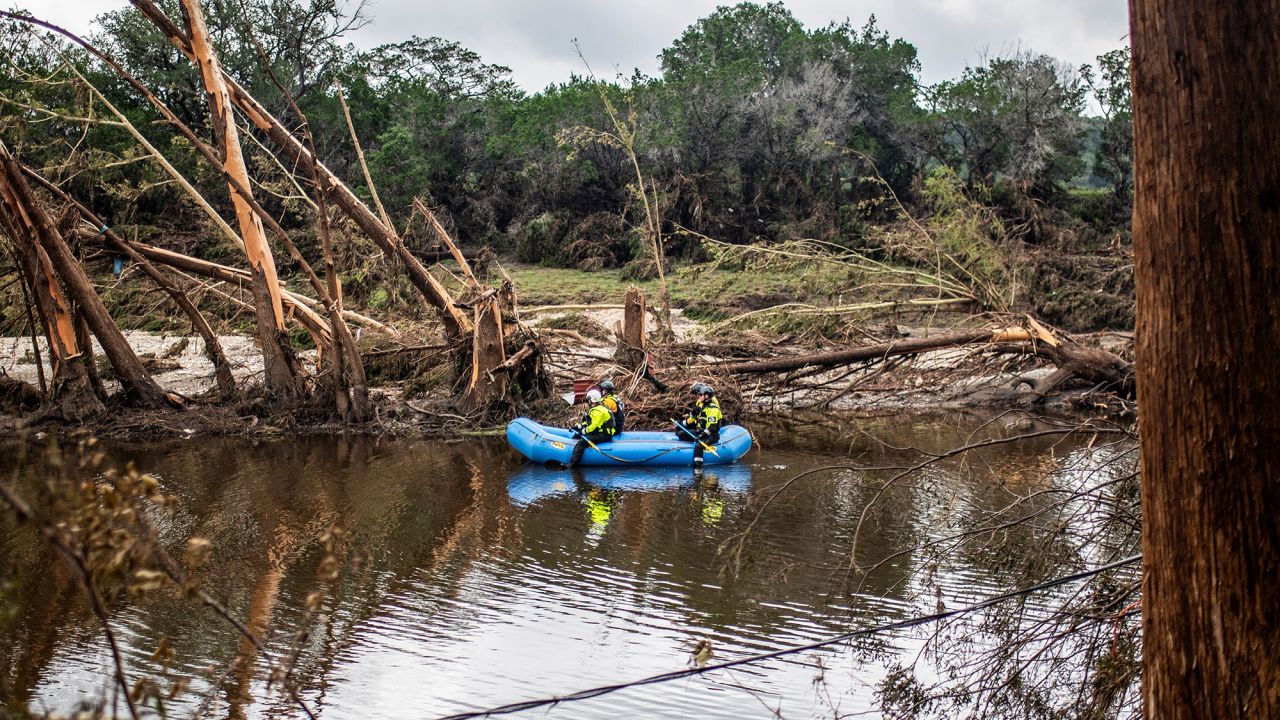 A group of search and rescue workers paddle a boat in the Guadalupe River in the aftermath of deadly flooding in Kerr County, Texas, U.S., July 7, 2025.   REUTERS/Sergio Flores