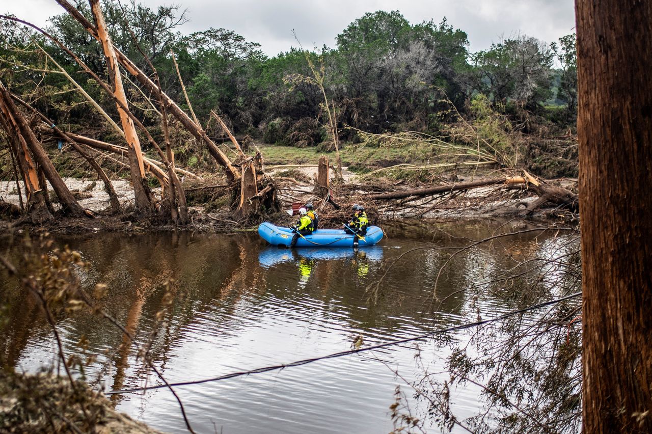 A group of search and rescue workers paddle a boat in the Guadalupe River in the aftermath of deadly flooding in Kerr County, Texas, on Monday.